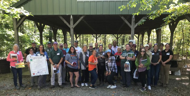 Group of adults in front of a picnic shelter
